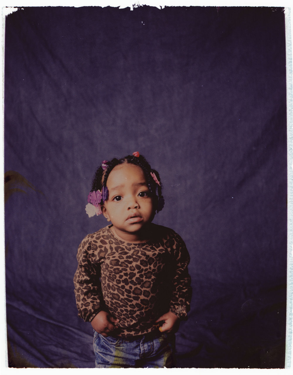 Negative Polaroid portrait of a little girl at New Moms