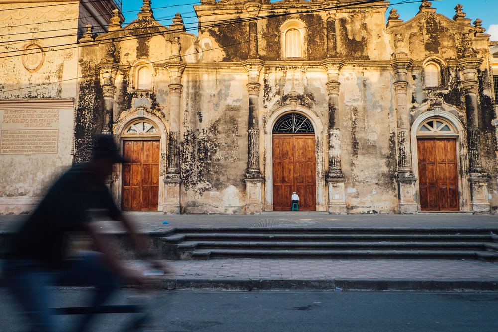 Man prays in the early morning at a church in Granada, NI